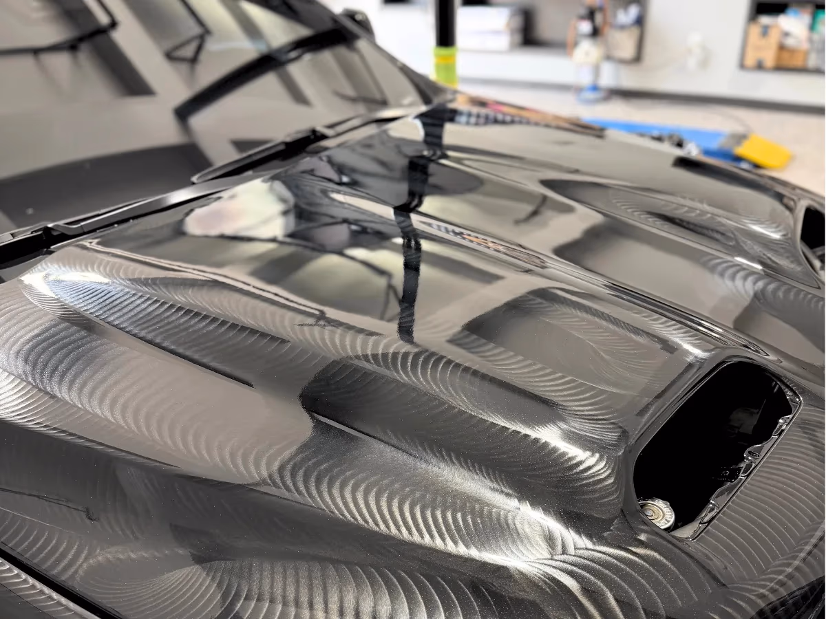Machine polisher compounding swirls out of a hood