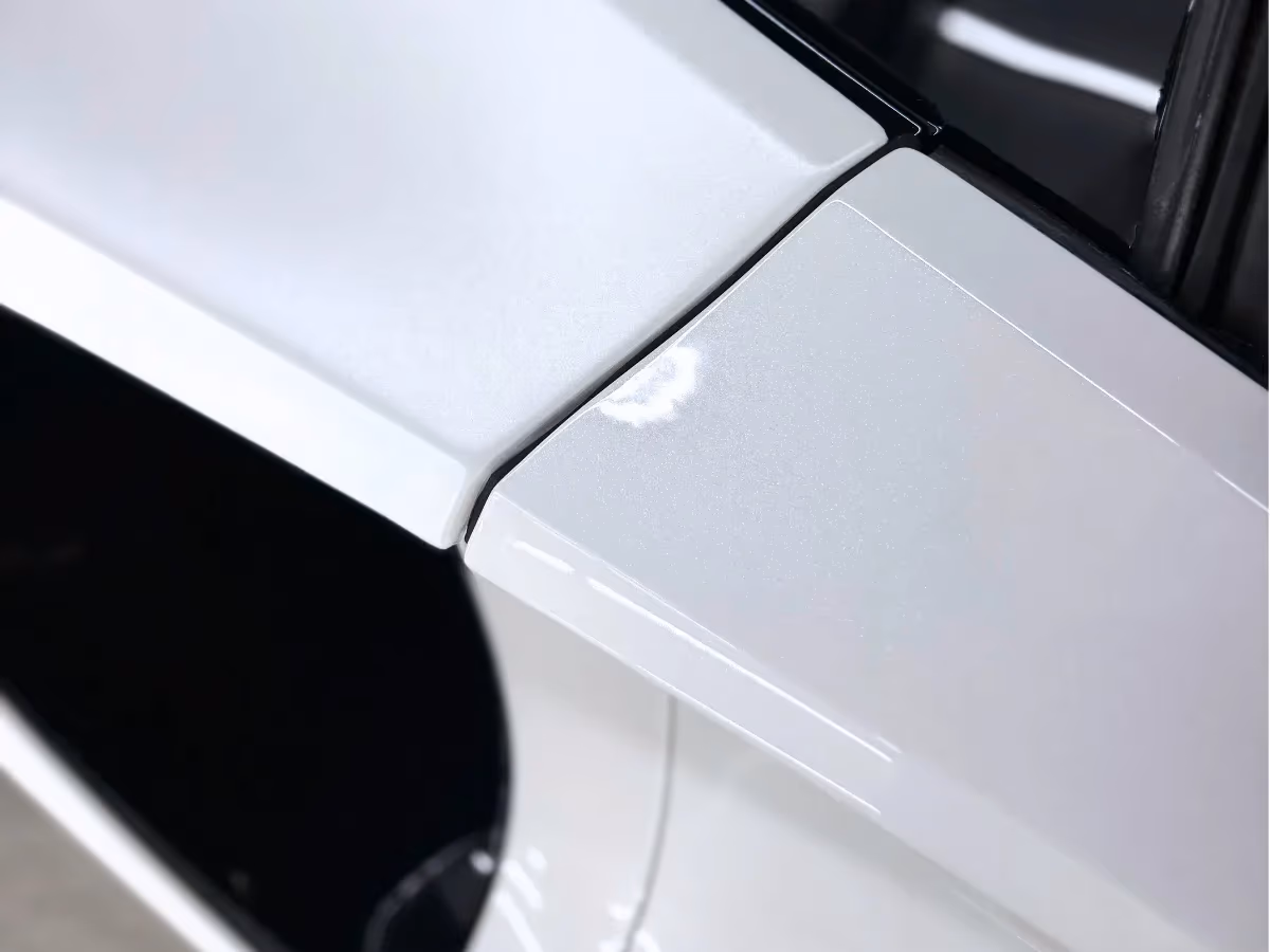 Paint protection film on the door edge of a white McLaren